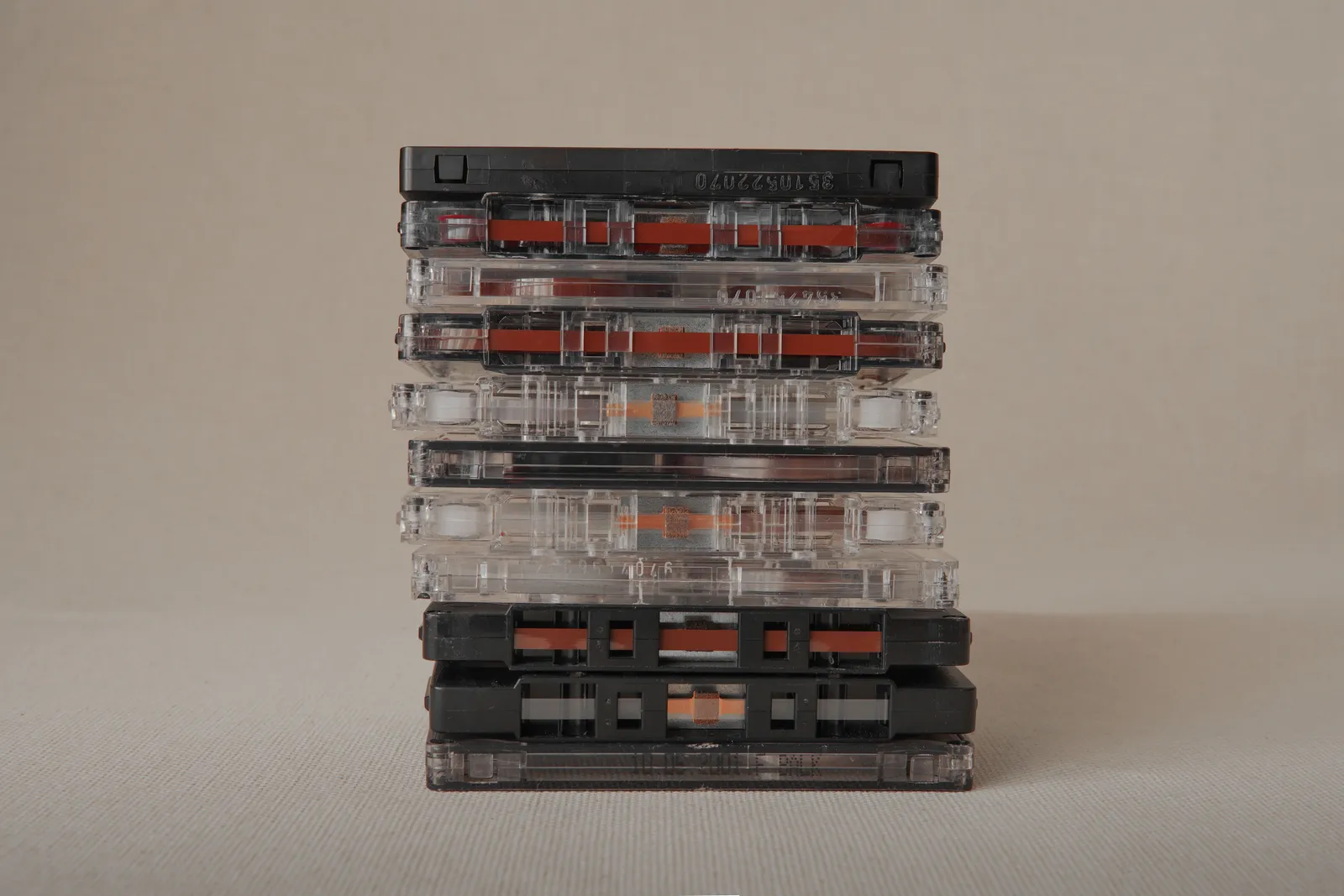A stack of classic cassette tapes photographed against a neutral backdrop. No people are depicted.