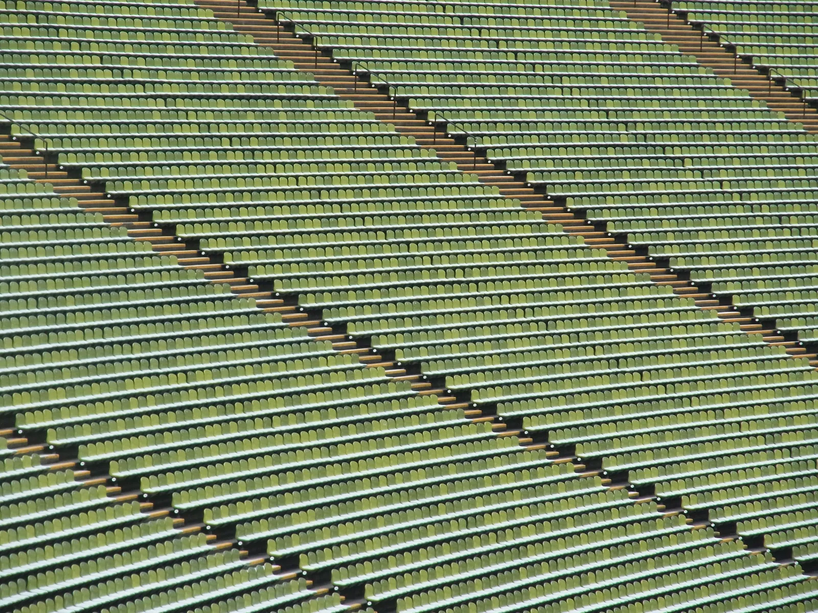 Rows of empty stadium bleacher seating arranged in a diamond pattern, an unrelated venue used here as a neutral stadium image.