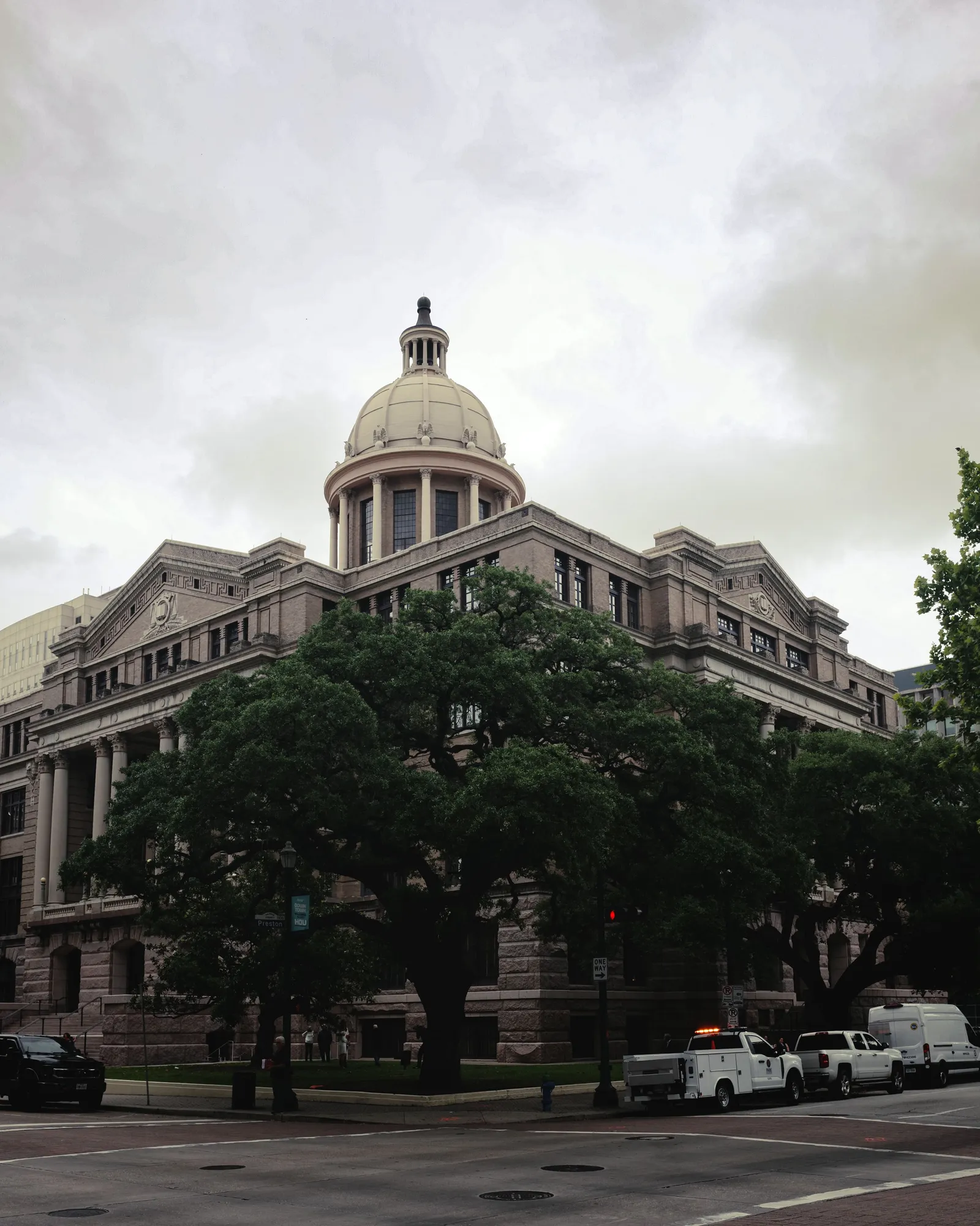 A Harris County courthouse exterior in Houston under an overcast sky.