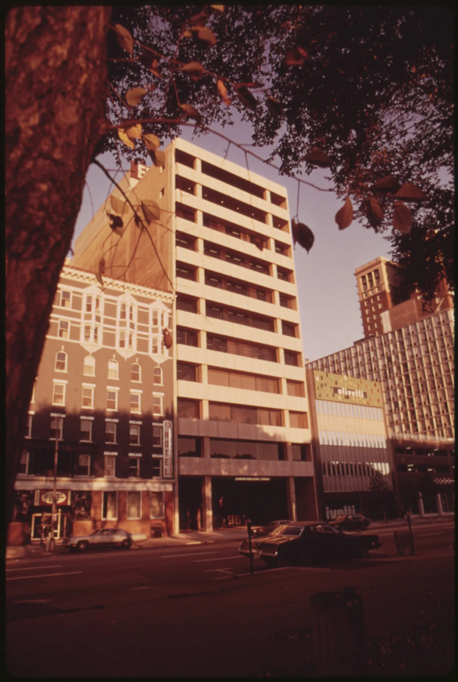 A black-and-white 1973 photograph of the Johnson Publishing Company headquarters, a modern multi-story office building with company signage, on Michigan Avenue in Chicago.