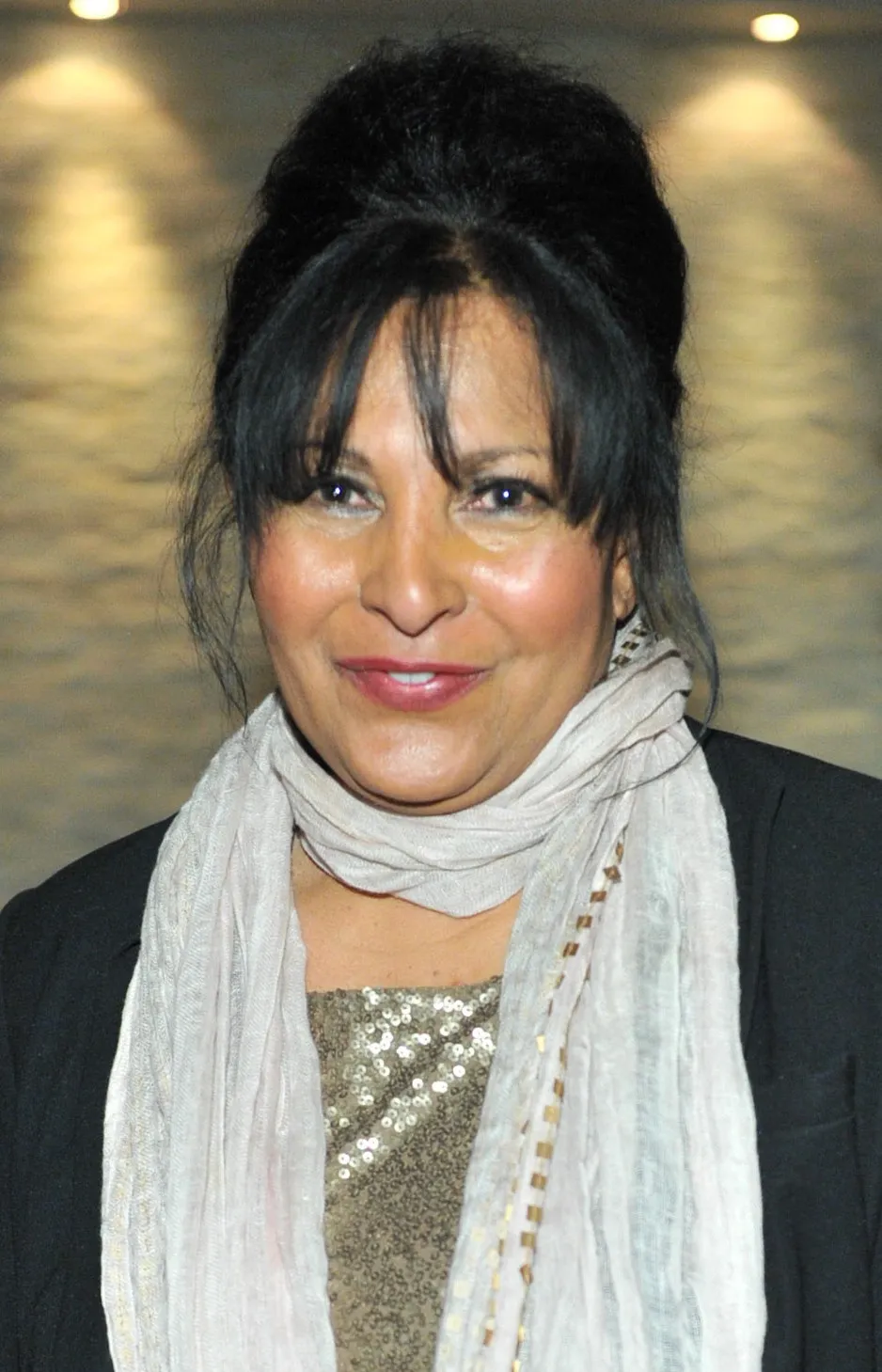 A color photograph of actress Pam Grier smiling at a public reception in Toronto in February 2012, decades after her 1971 appearance in Jet magazine.