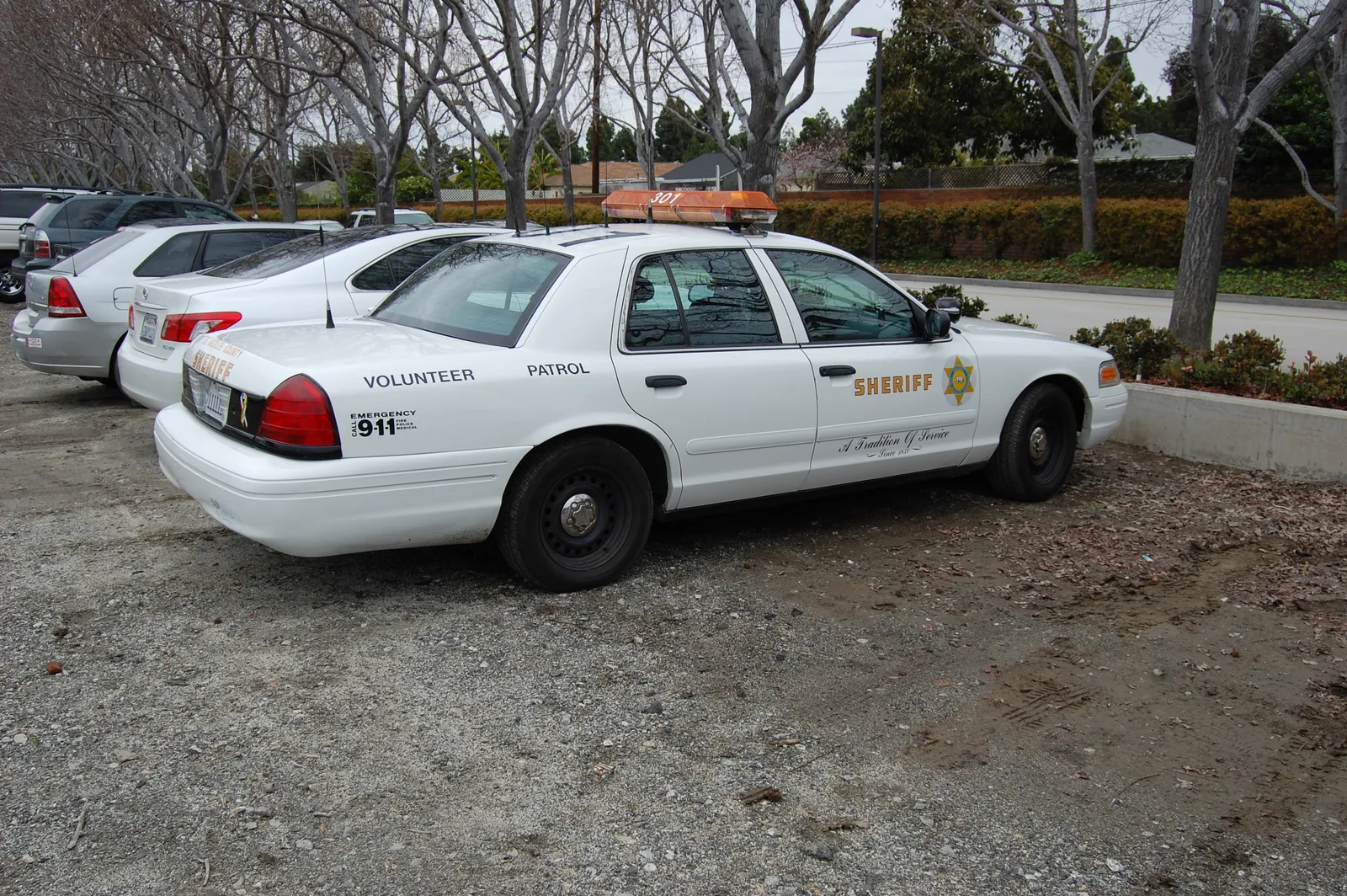 A Los Angeles County Sheriff's Department vehicle, marked as a Volunteer Patrol unit with the department's star badge and lettering, parked outdoors.