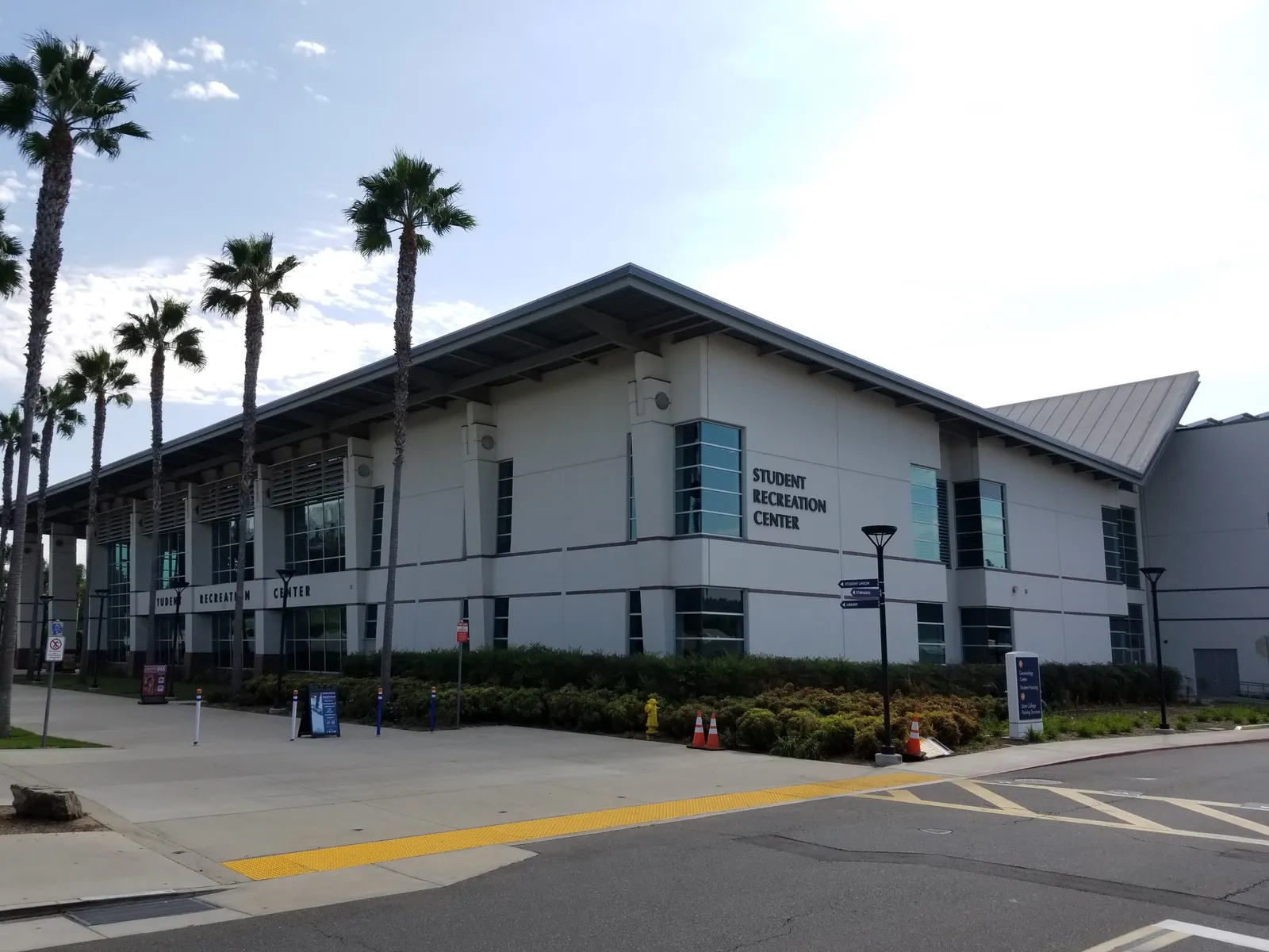 The Student Recreation Center building on the campus of California State University, Fullerton — the university where Mitrice Richardson earned her psychology degree — seen on a clear day with palm trees in the foreground.